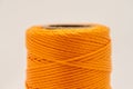 A roll of synthetic orange thread