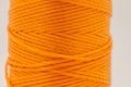 A roll of synthetic orange thread