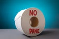 A roll of toilet paper on blue background close-up. The concept of panic purchasing of essential goods. Coronovirus, pandemic,