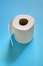 Roll of toilet paper on the blue background. Tissue for use in the toilet room, used for cleaning the dirt in the bathroom. Royalty Free Stock Photo