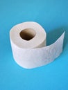 Roll of toilet paper on the blue background. Tissue for use in the toilet room, used for cleaning the dirt in the bathroom.