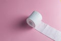 A roll of toilet paper isolated on the pink background Royalty Free Stock Photo