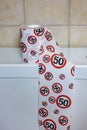 Roll of toilet paper with sign for speed limit 50