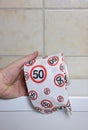 Roll of toilet paper with traffic signal speed limit 50