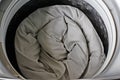 Roll up the duvet and put it in the washing machine. Royalty Free Stock Photo