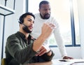 Roll up your sleeves and get to work. a young male call center worker receiving direction from his boss. Royalty Free Stock Photo