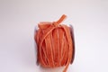 A roll of velvet pink orange for floristics and gift wrapping with a cute bow on the side