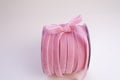 A roll of velvet pink ribbon for floristics and gift wrapping with a cute bow on the side