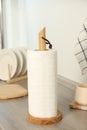 Roll of white paper towels and other kitchen stuff on wooden countertop indoors Royalty Free Stock Photo