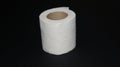 Roll of white toilet paper on a black background Royalty Free Stock Photo