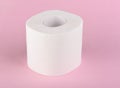 A roll of white toilet paper isolated on a pink background. The paper product used in the sanitary and hygienic purposes Royalty Free Stock Photo