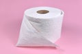 Roll of white toilet paper on pink background Royalty Free Stock Photo