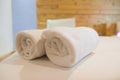 Roll of white towel on bed Royalty Free Stock Photo