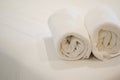 Roll of white towel on bed Royalty Free Stock Photo