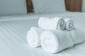 Roll of white towel on the bed table in Luxury modern hotel room Royalty Free Stock Photo