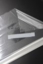 roll of white transparent film for baking with zippers on a black background, top view. Royalty Free Stock Photo