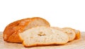 Roll of white white bread and three cut off chunks Royalty Free Stock Photo