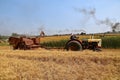 International combine and Case tractor harvesting grain