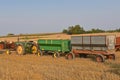 John Deere tractor pulling grain wagons