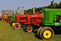 Row of restored various tractor models Royalty Free Stock Photo