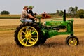 Father and Son driving a General Purpose John Deere tractor Royalty Free Stock Photo