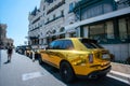 Rollce-Royce Cullinan in golden color next to fmous casino