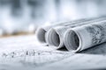 Rolled architectural blueprints with detailed technical drawings on a workspace Royalty Free Stock Photo