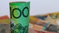 An rolled Australian twenty dollar note with a background of notes. Royalty Free Stock Photo