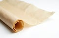 Rolled baking parchment paper sits on a clean white surface. This kitchen essential is perfect for food prep and baking needs. It Royalty Free Stock Photo