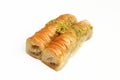 Rolled baklava with pistachios isolated on white background. Turkish delicacy