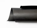 Rolled black art paper isolated on white background