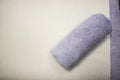 Rolled blue towel on massage table