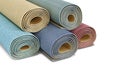 Rolled carpets are stacked together on a white background, Royalty Free Stock Photo