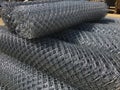 Rolled chain-link fence. Metal mesh netting rolled into rolls