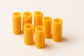 Rolled cheddar cheese slices upright columns zigzag line with backlight on white background for dairy snack cheeseboard party and Royalty Free Stock Photo