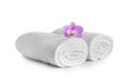 Rolled clean soft towels with flower on white background Royalty Free Stock Photo