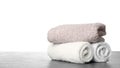 Rolled clean towels for bathroom on table against white background. Space for text Royalty Free Stock Photo