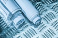 Rolled construction plans on channeled metal sheet Royalty Free Stock Photo