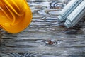 Rolled construction plans hard hat on vintage wooden board Royalty Free Stock Photo