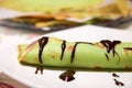 Rolled crepe to the taste of mint garnished with chocolate