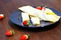 Rolled Crepes with strawberries on white plate on wooden background Royalty Free Stock Photo