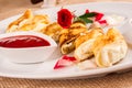 Rolled crepes stuffed with curd and berry jam