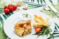 Rolled Delicious Crepes stuffed with chicken and mushrooms on the white plate serving with sour cream. Pancake is a flat Royalty Free Stock Photo