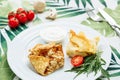 Rolled Delicious Crepes stuffed with chicken and mushrooms on the white plate serving with sour cream. Pancake is a flat Royalty Free Stock Photo