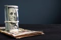 Rolled dollar banknotes on a desk with free space