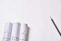 Rolled engineering drawings and pencil at blank white background with copy space Royalty Free Stock Photo