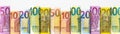 Rolled euro banknotes in various denominations arranged in a row on a white background Royalty Free Stock Photo