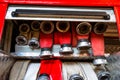 Rolled fire hoses, arranged in rows, in the glove compartment of the fire truck.