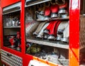 Rolled fire hoses, arranged in rows, in the glove compartment of the fire truck.