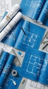 Rolled and flat blue architectural blueprints spread across a table. Includes open and Royalty Free Stock Photo